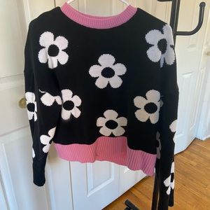 Lightly worn black sweater with white flowers